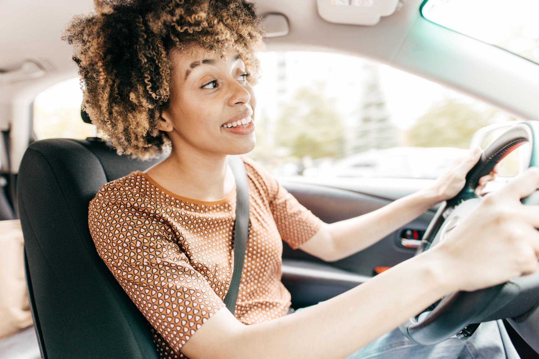 Driver smiling inside modern vehicle